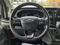 Steering wheel of a 2020 Ford Transit with control buttons and the Ford emblem displayed in the center