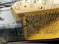 A close-up view of a control panel for a 2024 Caterpillar 306 featuring various symbols and instructions related to its operations and maintenance
