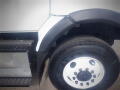 Close-up of the front wheel and fender of a 2016 International WorkStar 7500 showing the tire tread and rim details