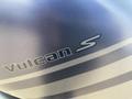 Close-up of a metallic blue 2020 Kawasaki Vulcan S motorcycle logo with a sleek design and silver stripes