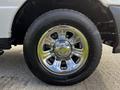 Close-up of a shiny chrome wheel from a 2010 Ford Ranger featuring a multi-spoke design with a Firestone tire mounted on it