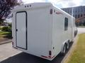 White 2004 Royal 18 Foot Office Trailer with a rear door and dual wheels parked on a solid surface