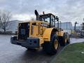 A yellow Hyundai HL770-9A wheel loader with a large bucket attachment positioned at the front and a prominent exhaust stack on the top