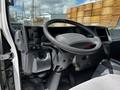 Interior view of a 2016 Isuzu NQR showing the steering wheel dashboard and controls