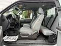 Interior of a 2015 Ford F-350 SD showing front seats and dashboard with gray upholstery and a console in between