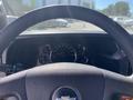 Steering wheel and dashboard of a 2020 Chevrolet Express showing speedometer fuel gauge and various controls