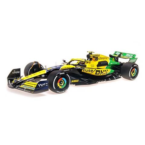 Minichamps McLaren MCL38 2024 Monaco Grand Prix #4 L Norris 1:12 scale model car in yellow black and green color scheme with detailed design and sponsor logos