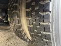 Close-up of a tire with detailed tread pattern on a 2013 International Durastar 4300 vehicle showing wear and texture