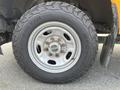 Close-up of a tire and wheel assembly from a 2017 Ford F-250 SD featuring a silver rim and an all-terrain tire with visible tread patterns