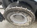 A worn tire from a 2011 Toyota 028FG15 forklift showing dirt and wear on the tread