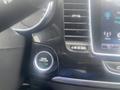 A close-up of the engine start-stop button in a 2018 Buick Encore with a green light indicating the engine is ready to start