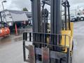 A yellow 2010 Hyster S80XLBCS forklift with a chain lift mechanism and fork attachments in a parking area