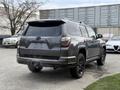A gray 2021 Toyota 4Runner parked with its back facing the viewer showcasing its sleek design and blacked-out wheels