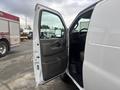 2022 GMC Savana van with an open driver's side door revealing the interior seating and dashboard area