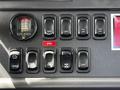 Dashboard controls of a 2012 Freightliner M2 106 with various switches for lights and functions including PTO and filter indicator
