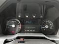 Dashboard of a 2011 Ford F-550 displaying gauges for RPM speed fuel level and engine temperature with warning lights illuminated