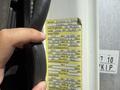 A person holding a yellow spec sheet for a 2009 International 7500 truck displaying weight limits and tire specifications