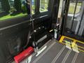 Interior view of a 2016 RAM Promaster showing a wheelchair lift with a safety harness and a red toolbox positioned below the control panel
