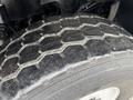 Close-up of a tire from a 2012 International WorkStar featuring a honeycomb tread pattern with visible wear and texture