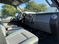 Interior view of a 2014 Ford F-550 showing the dashboard seat and steering wheel designed for heavy-duty use