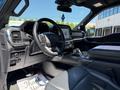 Interior view of a 2021 Ford F-150 showcasing the steering wheel dashboard and center console with modern controls and leather seating