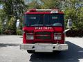 A red 2006 Emergency One fire truck with the words FIRE DEPT displayed prominently on the front and chrome details around the headlights and bumper