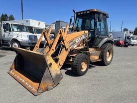 A 2011 Case 570 MXT backhoe loader with a yellow and black exterior and a front bucket attachment