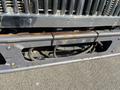Close-up of the front bumper and grille of a 2007 International 7300 showing signs of wear and rust with visible mounting brackets and hoses