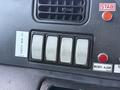 Control panel of a 2017 Autocar Xpert featuring four gray buttons labeled Up and Down along with indicator lights and various operational labels