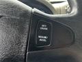 Close-up of a black steering wheel control panel featuring buttons for cruise control labeled 'SET/CRUISE' and 'RESUME/ACCEL'