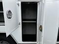 A 2020 Ford F-550 with open cargo doors revealing an empty storage compartment