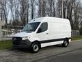 A 2022 Mercedes-Benz Sprinter van with a white exterior and black accents parked on a street