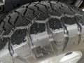 Close-up of a wet tire tread of a 2017 Ford F-150 showcasing its rugged pattern and texture
