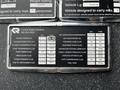 A metal identification plate listing vehicle specifications and fluid types for a 2009 Spartan Gladiator including engine oil and transmission fluid details