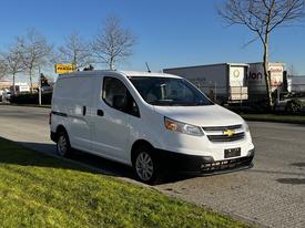 A white 2015 Chevrolet City Express van parked on a street with a clean design featuring a distinctive Chevrolet front grille and side windows