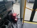 A red fire extinguisher rests on the floor next to the driver's seat of a 2017 Chevrolet Express