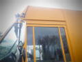 A yellow 2008 Freightliner MT45 Chassis with a large front windshield and a side view mirror