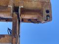 Close-up of the boom of a 2008 Case Super 580M construction vehicle showing rusted metal components and hydraulic lines