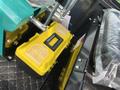 2024 AGT Industrial Green QH13R Mini Excavator with a yellow toolbox positioned on a surface inside the cabin