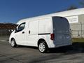 A white 2017 Nissan NV200 van is parked at an angle showing its side and rear view with no visible license plate on the back