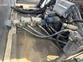 A close-up of machinery components including valves and hoses from a 2015 Global Street Sweeper showing intricate connections and mechanical parts