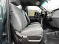 A 2012 Ford F-550 with gray cloth seats facing forward showing the interior design and layout of the front cabin