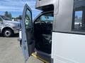 A 2017 Chevrolet Express with an open driver's door revealing the steering wheel and dashboard interior