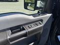 Close-up of the interior door panel of a 2014 Ford F-250 SD featuring window controls and a door handle
