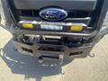A 2016 Ford F-350 SD front bumper showing fog lights winch and grille with the Ford logo