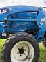 A blue 2021 LS XJ2025H tractor with a white wheel and visible details on the chassis