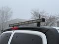 A 2016 GMC Savana with a roof-mounted light bar installed on the top rear section of the vehicle