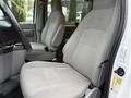 Interior of a 2013 Ford E-350 showing two grey cloth front seats and a dashboard area