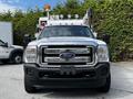 A 2016 Ford F-550 truck with a silver body and black grille equipped with a ladder and lights on top