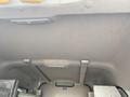 Interior view of a 2013 Ford Transit Connect showing the ceiling and storage area with metal supports and a light fixture